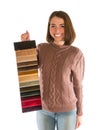 Cute smiling woman in sweater holding fabric swatches Royalty Free Stock Photo