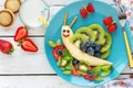 Cute smilingfresh fruit snail for kids breakfast