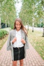 Cute smilling little girl posing in front of their school Royalty Free Stock Photo