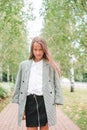 Cute smilling little girl posing in front of their school Royalty Free Stock Photo