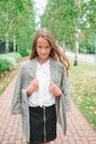 Cute smilling little girl posing in front of their school Royalty Free Stock Photo