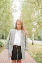 Cute smilling little girl posing in front of their school Royalty Free Stock Photo