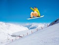 Cute snowboarder man jumping on ski resort Royalty Free Stock Photo