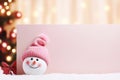 A cute snowman with a blank signboard. Winter holiday banner for Christmas greetings, announcements or promotional text. Royalty Free Stock Photo