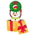 Cute snowman character in elf costume holding christmas wreath sitting in gift box in cartoon style Royalty Free Stock Photo