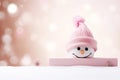 A cute snowman peek out of blank banner on blurred peach fuzz background. Winter holiday banner for Christmas greetings Royalty Free Stock Photo