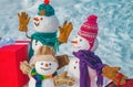 Cute snowmen family with - gift presents standing in winter Christmas landscape. Festive Art Greeting Card. Snowmen