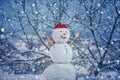Cute snowmen with - gift presents standing in winter Christmas landscape. New year gift. Snowman with shopping bag - Royalty Free Stock Photo