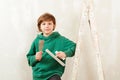 Cute son helps parents to repair room. Kid with tools. New house for family Royalty Free Stock Photo