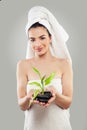 Cute Spa Girl with Green Bamboo Leaves and Massage Black Stones Royalty Free Stock Photo