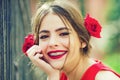 Cute spanish teen girl with red lips and roses in hair. Happy face. Royalty Free Stock Photo