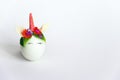 Spring Easter card with an unicorn egg with a rim of spring flowers and horn with copy space on a white background