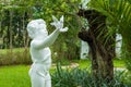 The cute statue in green garden.Thailand