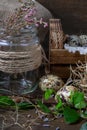 Cute still life with quail eggs. Quail eggs in the nest and on the old wooden table in the barn among vintage items and dried Royalty Free Stock Photo