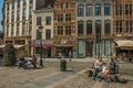 Cute street with people talking on public bench in Brussels.