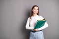 A cute student girl holds notebooks for notes and smiles Royalty Free Stock Photo