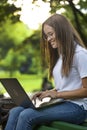 Cute Student Girl Using Laptop in Park Royalty Free Stock Photo