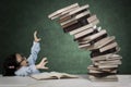 Cute student with pile of falling books