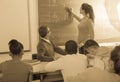 Cute student solves task near blackboard in classroom mathematics Royalty Free Stock Photo