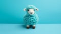 Turquoise Knitted Sheep Toy On Blue Background