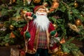 Cute stuffed toy Santa Claus giving a Christmas present. Stuffed toy Santa Claus, a bag of presents Royalty Free Stock Photo