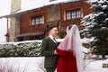 Cute stylish couple on wedding day. Bride and groom meet for the first time. First look. Winter wedding on snowfall with