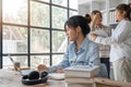 cute stylish female student, studying remotely from home, using a laptop, taking notes on notepad during online lesson Royalty Free Stock Photo