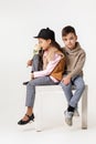 Cute stylish little couple child girl and boy sittting together .