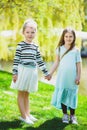 Cute stylish little girls playing at park outdoor Royalty Free Stock Photo