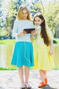 Cute stylish little girls posing at park outdoor Royalty Free Stock Photo