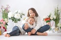 Cute stylish toddler child and older brother, boys with white shirt, playing with eggs and chocolate bunny on Easter decoration Royalty Free Stock Photo