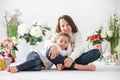 Cute stylish toddler child and older brother, boys with white shirt, playing with eggs and chocolate bunny on Easter decoration Royalty Free Stock Photo