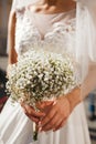 Cute stylish unusual wedding bouquet of flowers on the backgrou