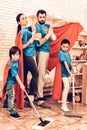 Cute Superhero Family Cleaning House with Kids. Royalty Free Stock Photo