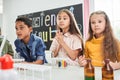 Cute surprised children with bated breath watching the chemical experiments