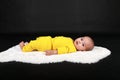 Surprised and curious baby boy lying on back on white fur Royalty Free Stock Photo