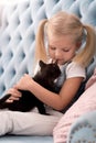 Cute sweet girl holding a black kitten Royalty Free Stock Photo