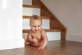 Cute sweet little blonde baby on wooden stairs background