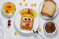 Cute sweet sandwich for kids with toast bread, chocolate spread, marmalade and fresh fruit Royalty Free Stock Photo