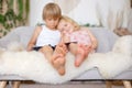 Cute sweet toddler children, tickling feet on the bed, laughing and smiling Royalty Free Stock Photo