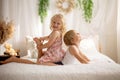 Cute sweet toddler children, tickling feet on the bed, laughing and smiling