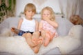Cute sweet toddler children, tickling feet on the bed, laughing and smiling Royalty Free Stock Photo