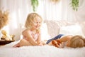 Cute sweet toddler children, tickling feet on the bed, laughing and smiling Royalty Free Stock Photo