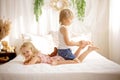 Cute sweet toddler children, tickling feet on the bed, laughing and smiling Royalty Free Stock Photo