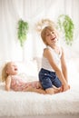 Cute sweet toddler children, tickling feet on the bed, laughing and smiling