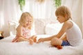 Cute sweet toddler children, tickling feet on the bed, laughing and smiling Royalty Free Stock Photo