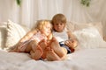 Cute sweet toddler children, tickling feet on the bed, laughing and smiling Royalty Free Stock Photo