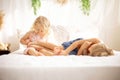 Cute sweet toddler children, tickling feet on the bed, laughing and smiling Royalty Free Stock Photo