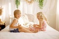 Cute sweet toddler children, tickling feet on the bed, laughing and smiling Royalty Free Stock Photo