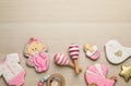 Cute tasty cookies of different shapes with toys and space for text on white wooden table, flat lay. Baby shower party Royalty Free Stock Photo